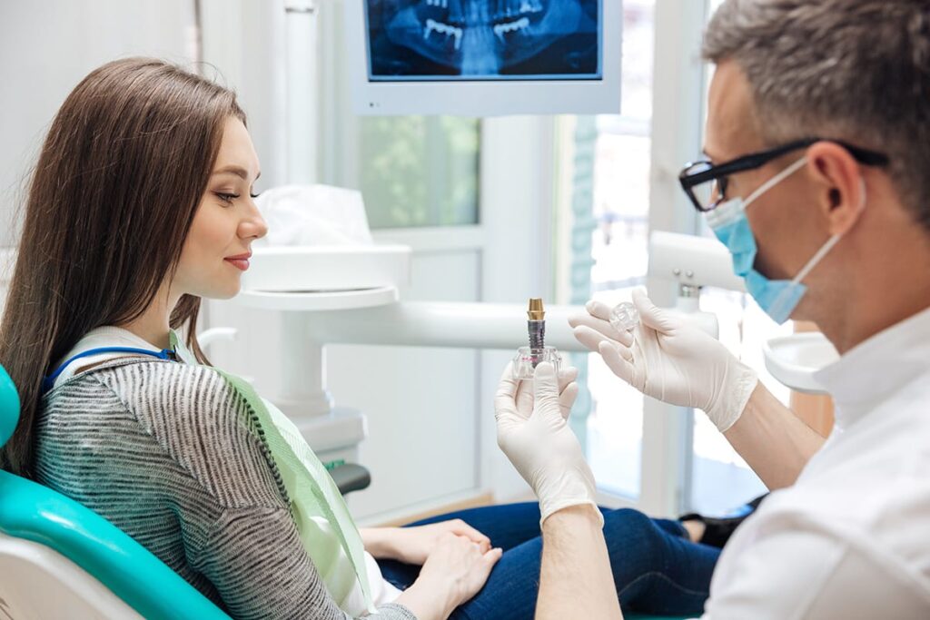 prosthodontist answering the question what is a dental implant for a curious patient