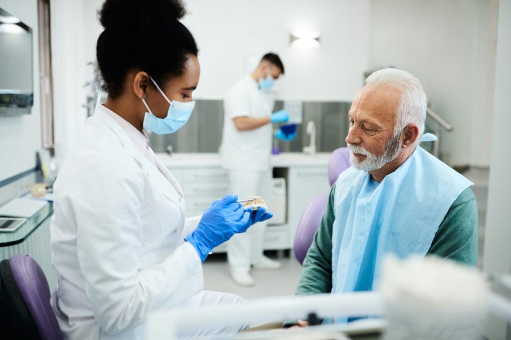 older gentleman in dental exam exploring his denture options