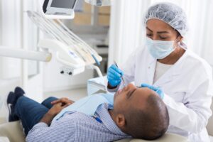 man in dental chair undergoing prosthodontic dental services