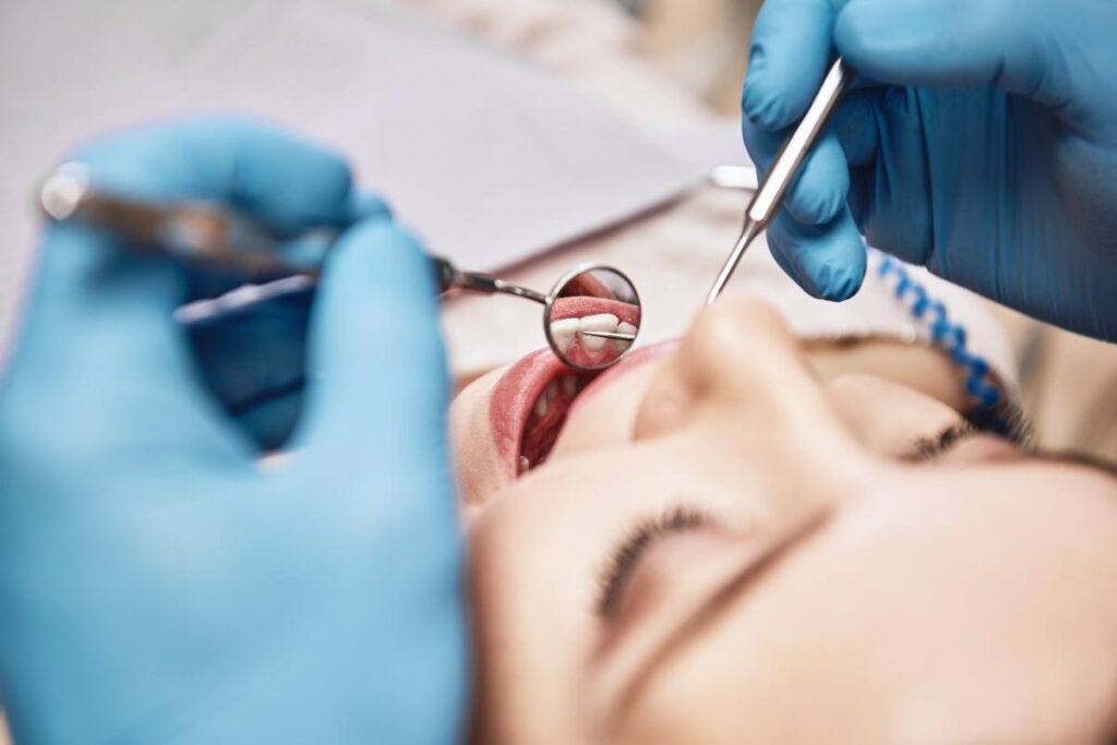 Woman undergoing tooth extraction surgery after learning about signs you need a tooth pulled