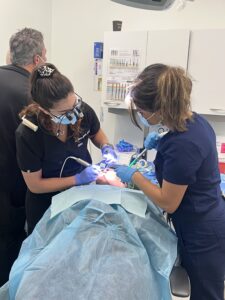 students with dentist in implant courses for general dentist
